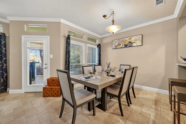 a view of a dining room with furniture and chandelier