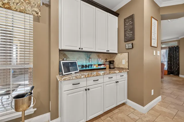 a kitchen with a stove and a white cabinet