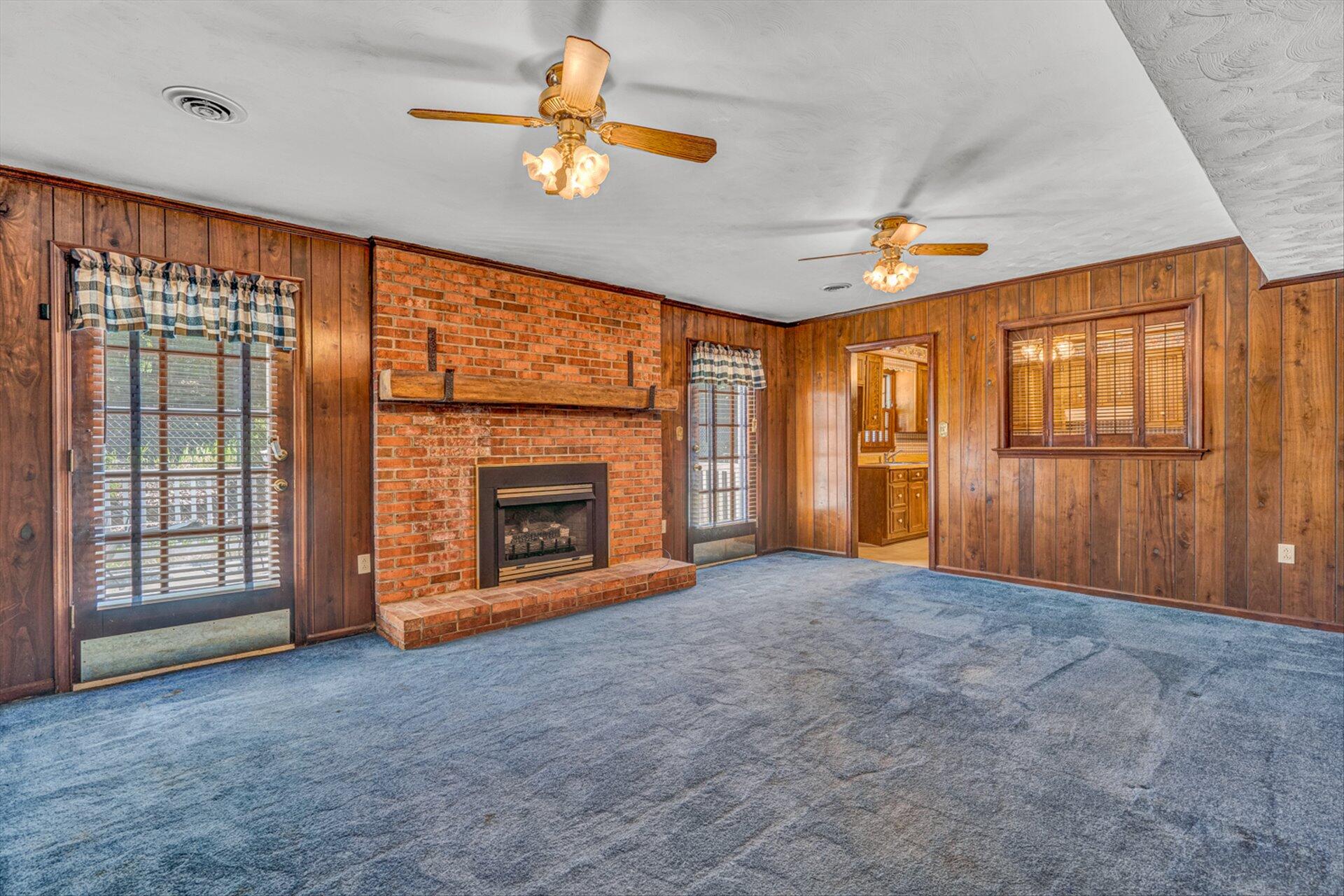 368 Foxcroft Drive Blue Ridge, VA 24064 - Photo 14 of 39 an empty room with windows chandelier and fireplace