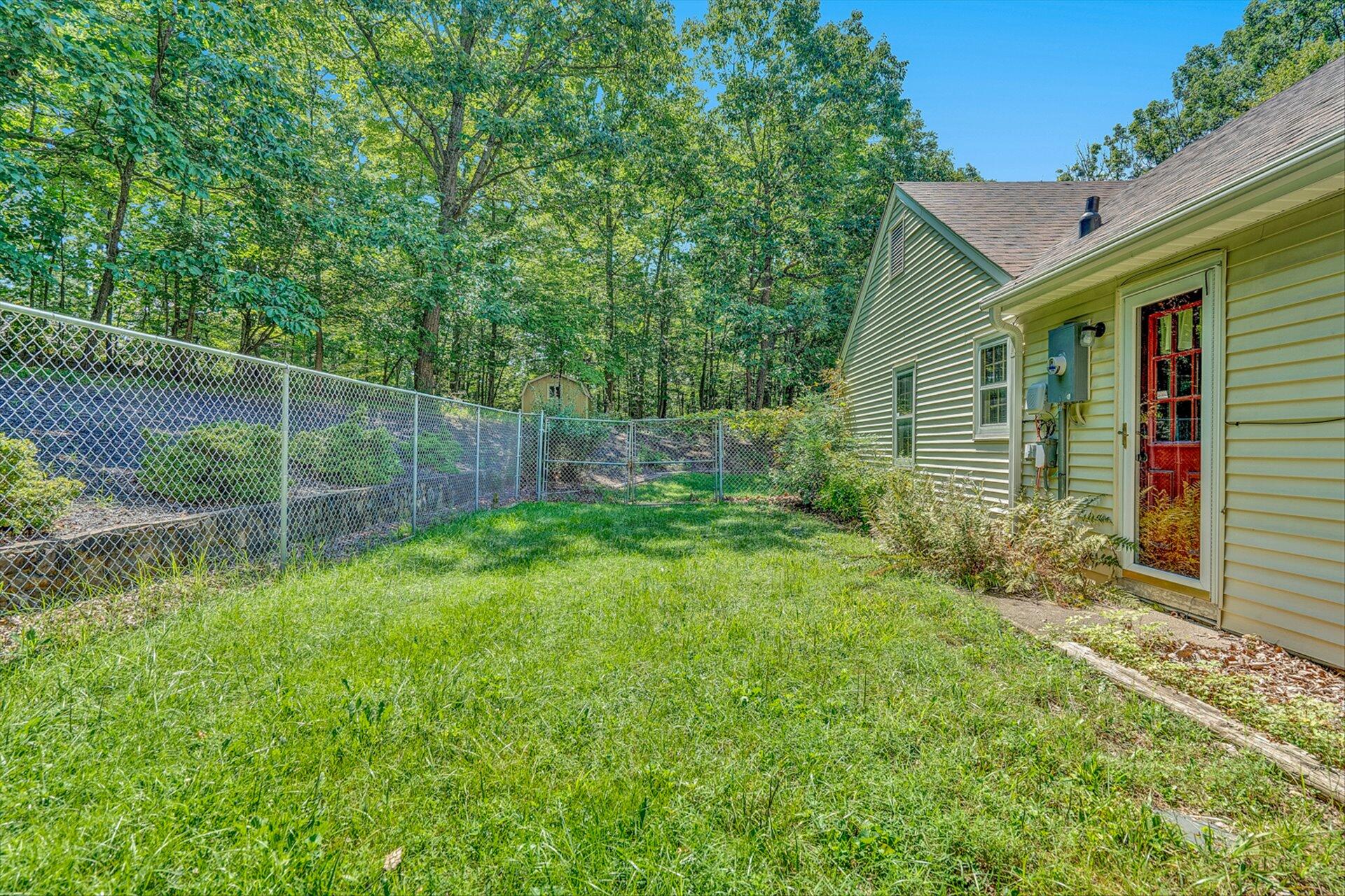 368 Foxcroft Drive Blue Ridge, VA 24064 - Photo 33 of 39 a backyard of a house with plants and large tree