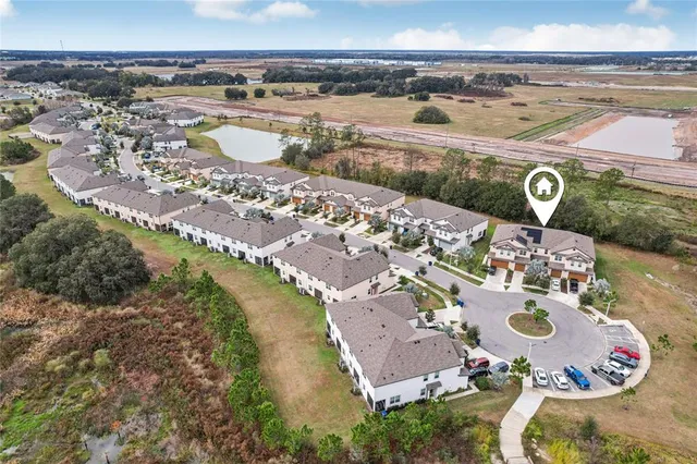 an aerial view of a house with outdoor space