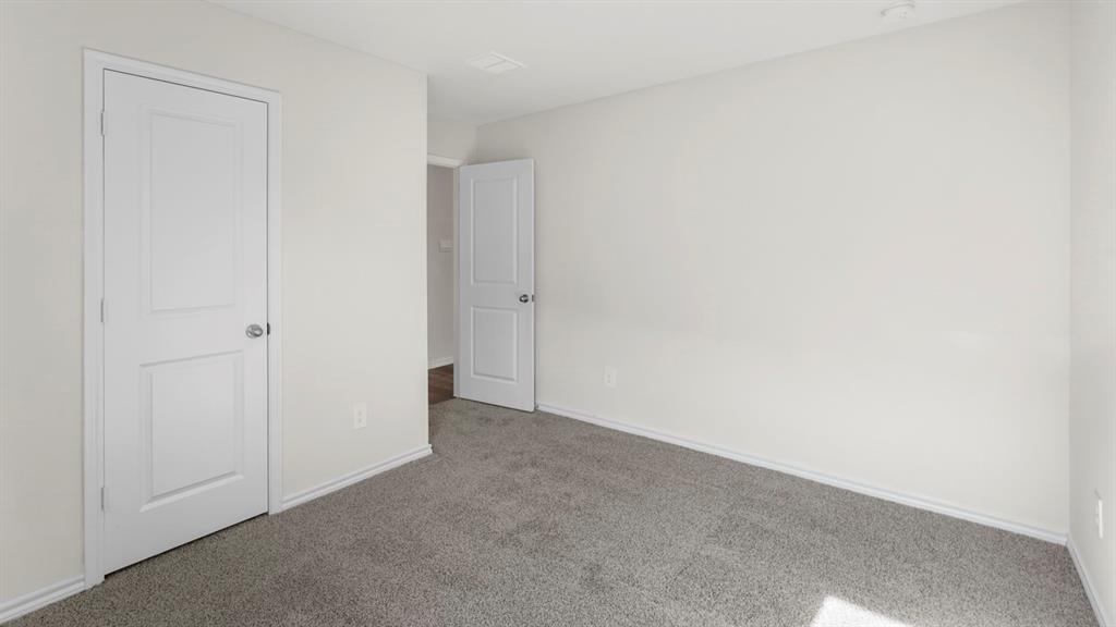 1969 Freeman Street Tyler, TX 75704 - Photo 23 of 30 Room featuring light gray carpeting, neutral wall paint, and white trim