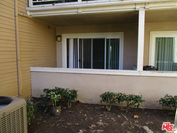 a vase of flowers sitting on a floor