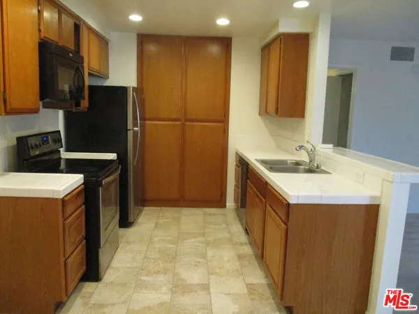 a kitchen with a sink stove and refrigerator