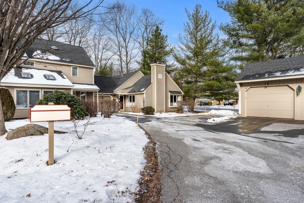 4 Iris Way, Unit 22 Haverhill, MA 01830 - Photo 2 of 38 a front view of a house with a yard and garage