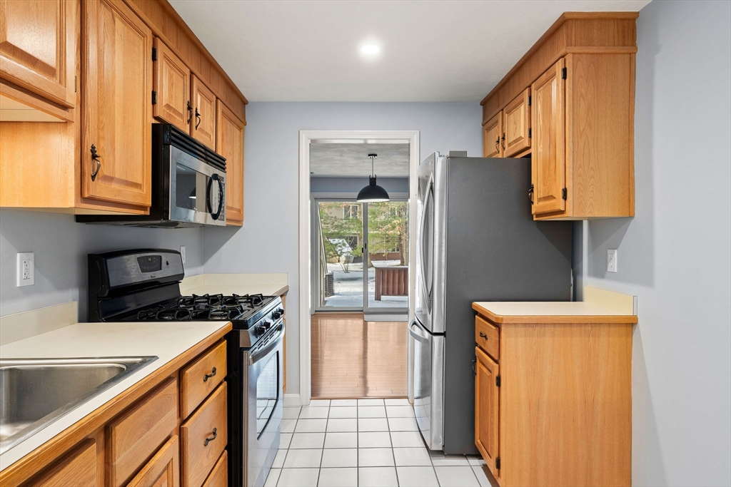 4 Iris Way, Unit 22 Haverhill, MA 01830 - Photo 22 of 38 a kitchen that has a sink a stove and a refrigerator
