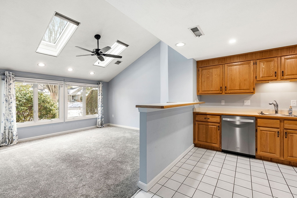 4 Iris Way, Unit 22 Haverhill, MA 01830 - Photo 23 of 38 a kitchen with stainless steel appliances granite countertop a stove sink and cabinets