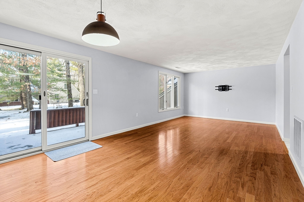 4 Iris Way, Unit 22 Haverhill, MA 01830 - Photo 26 of 38 a view of empty room with wooden floor and fan