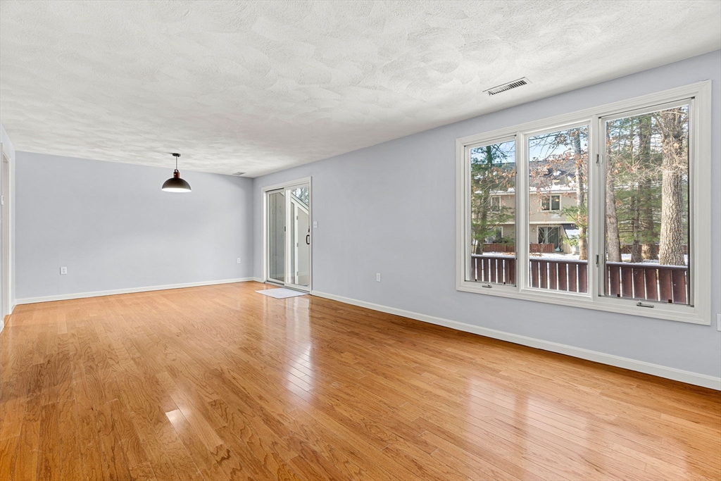 4 Iris Way, Unit 22 Haverhill, MA 01830 - Photo 29 of 38 a view of an empty room with wooden floor and a window