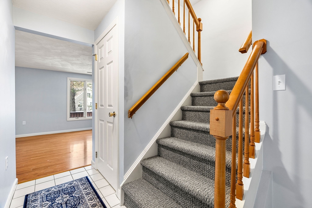 4 Iris Way, Unit 22 Haverhill, MA 01830 - Photo 31 of 38 a view of staircase with wooden floor and a rug