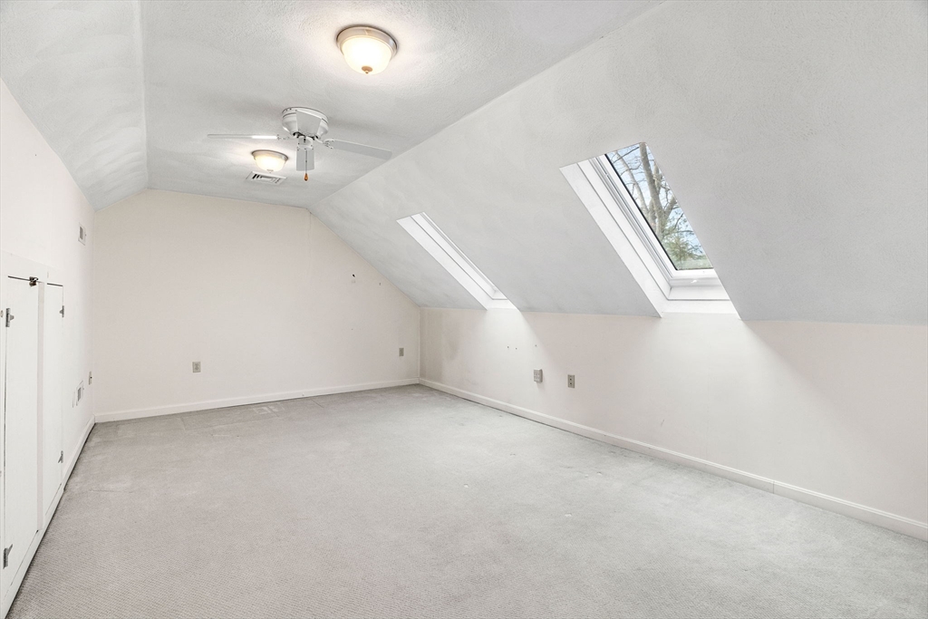 4 Iris Way, Unit 22 Haverhill, MA 01830 - Photo 6 of 38 an empty room with a window and ceiling fan