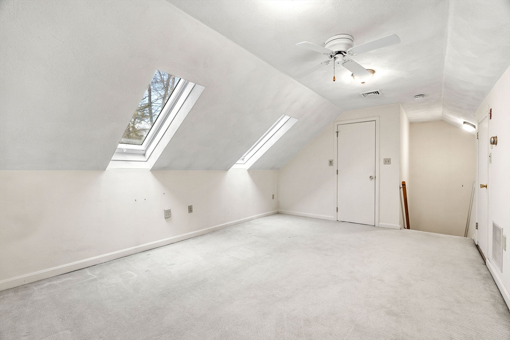 4 Iris Way, Unit 22 Haverhill, MA 01830 - Photo 7 of 38 an empty room with windows and chandelier fan