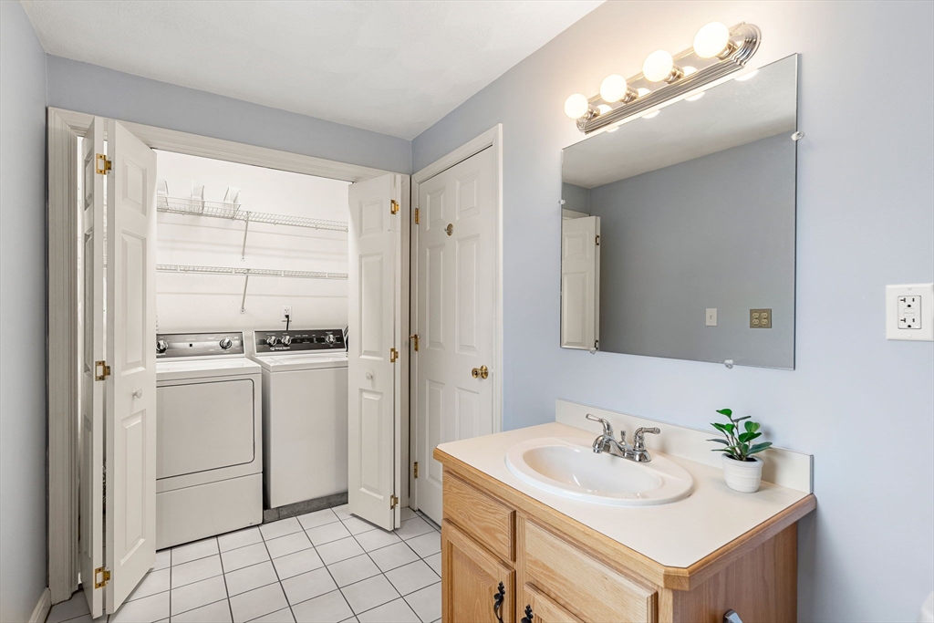 4 Iris Way, Unit 22 Haverhill, MA 01830 - Photo 9 of 38 a bathroom with a sink toilet and mirror