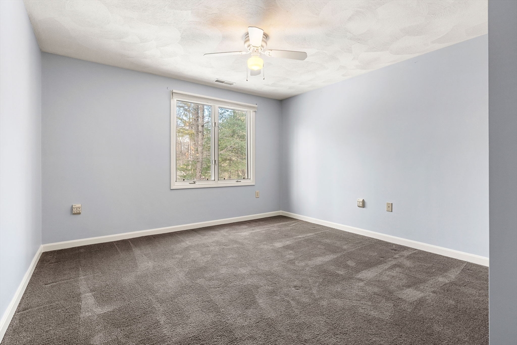 4 Iris Way, Unit 22 Haverhill, MA 01830 - Photo 10 of 38 an empty room with windows and ceiling fan