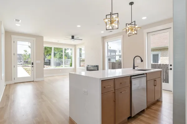 a spacious bathroom with a double vanity sink a large mirror and a bathtub