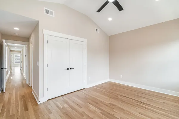 a view of walk in closet with wooden floor