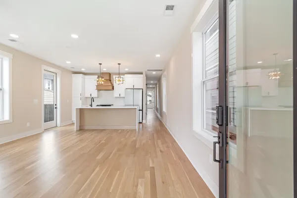 a view of a kitchen with wooden floor and a kitchen