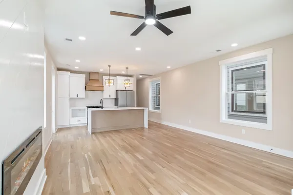 a view of kitchen with sink and refrigerator