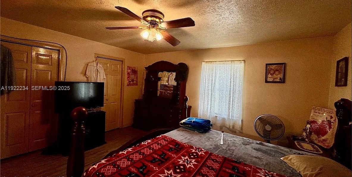 8055 Twitty Road Sebring, FL 33876 - Photo 17 of 19 a bedroom with furniture and wooden floor