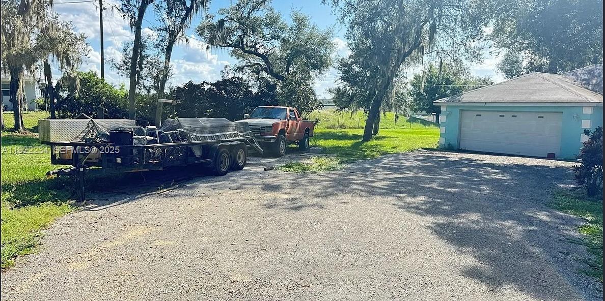 8055 Twitty Road Sebring, FL 33876 - Photo 4 of 19 a view of backyard with a garden and trees