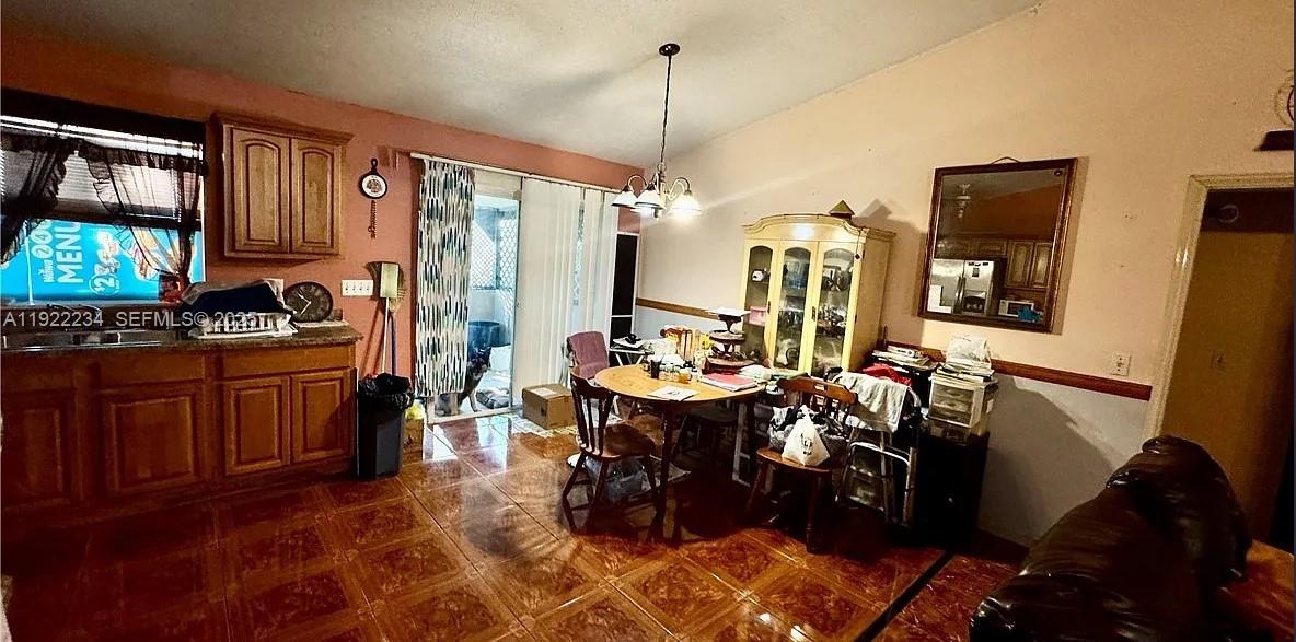 8055 Twitty Road Sebring, FL 33876 - Photo 9 of 19 a view of a dining room with furniture window and wooden floor