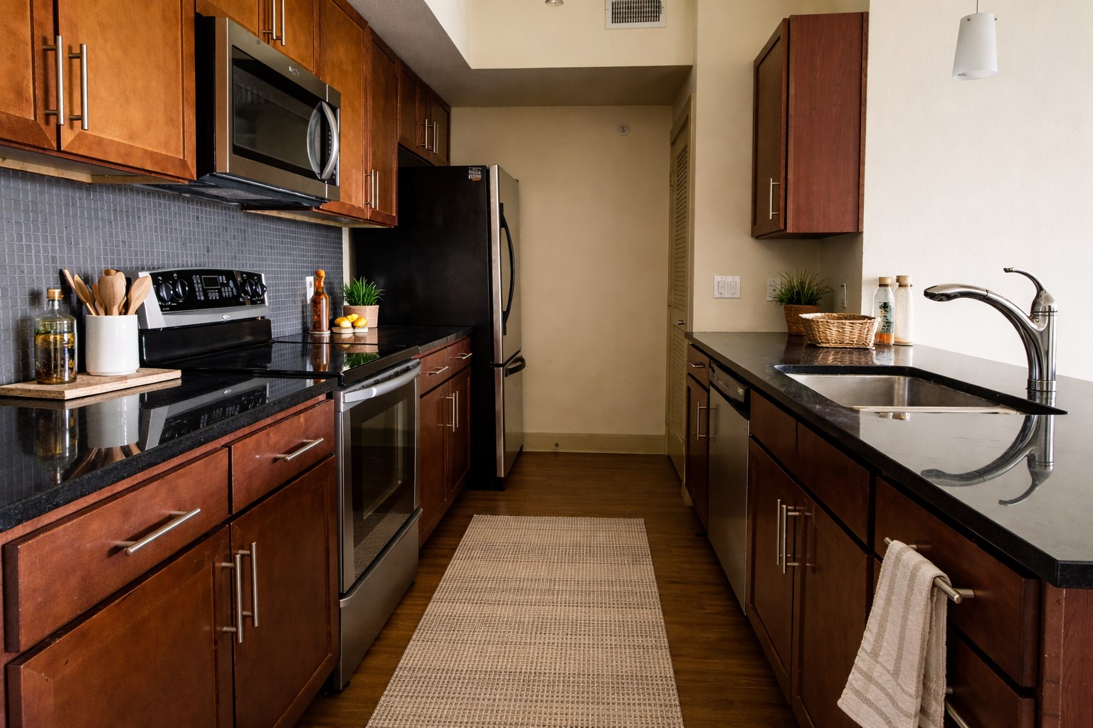 3016 Guadalupe Street, Unit 203 Austin, TX 78705 - Photo 7 of 16 a kitchen with stainless steel appliances granite countertop a sink stove and refrigerator