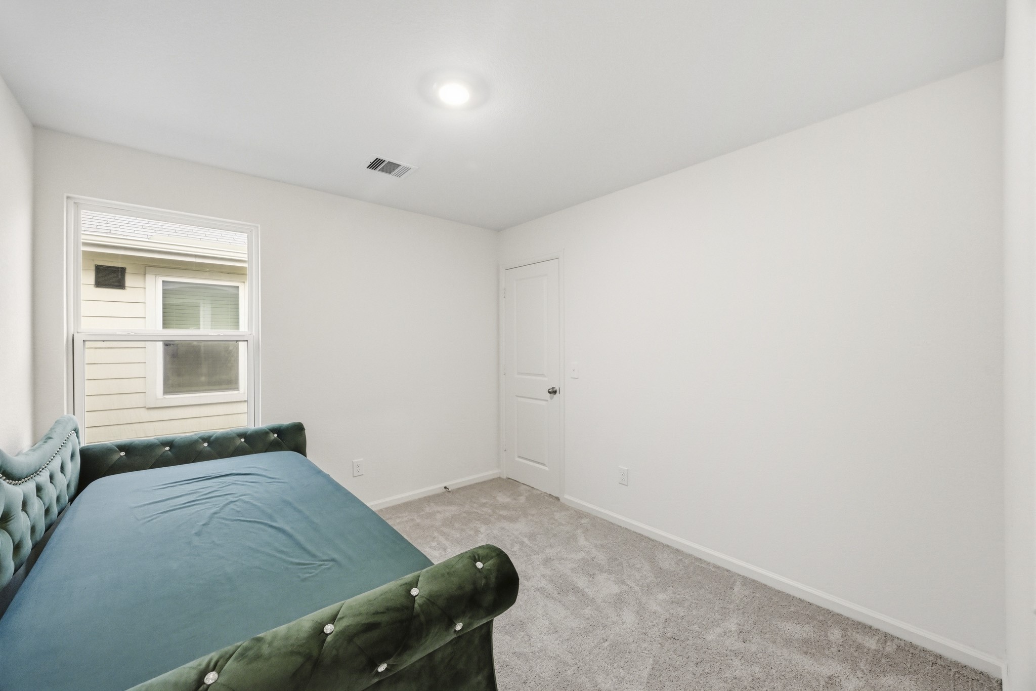 7207 Evitale Way Houston, TX 77049 - Photo 25 of 43 a bedroom with a bed and a window