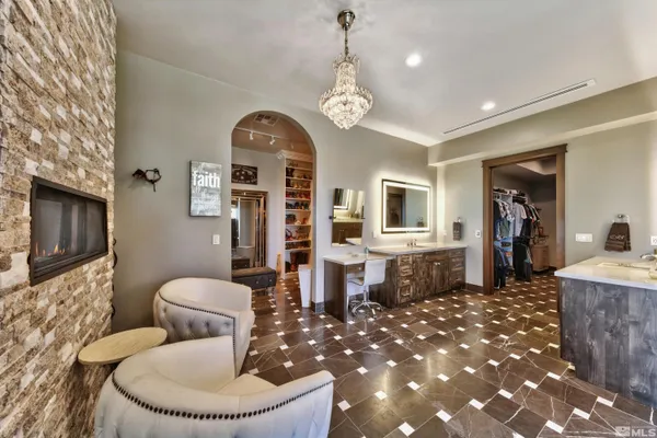 a living room with furniture a fireplace and a chandelier