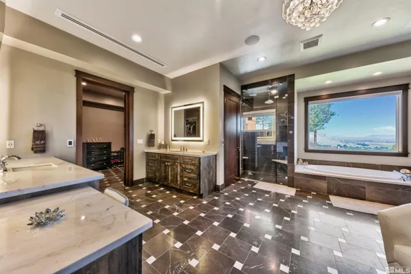 a spacious bathroom with a sink a large mirror and a shower