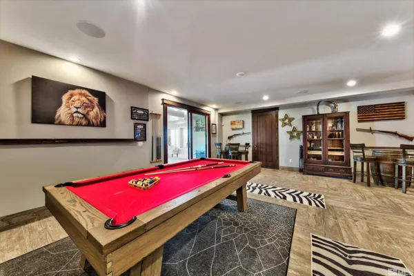 a room with gym equipment pool table and window