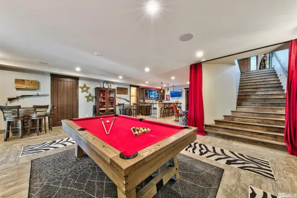 a room with pool table table and chairs