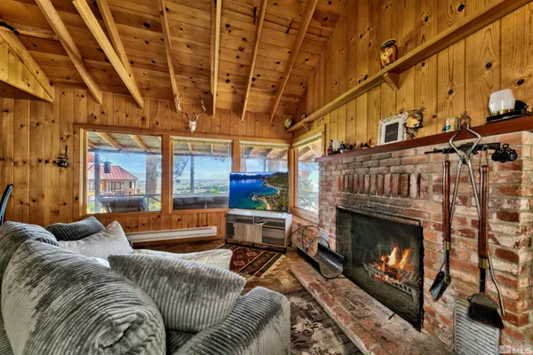 a living room with furniture a fireplace and a table