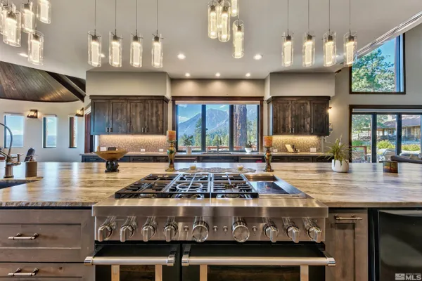 a kitchen with stainless steel appliances granite countertop a stove a sink dishwasher and cabinets