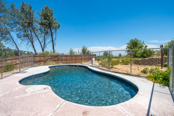 a view of a swimming pool with a patio