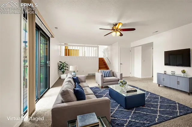 a living room with furniture and a flat screen tv