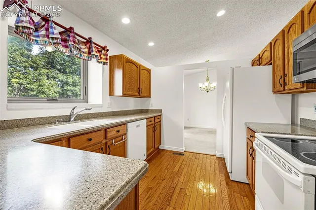 a kitchen with a sink stove and refrigerator