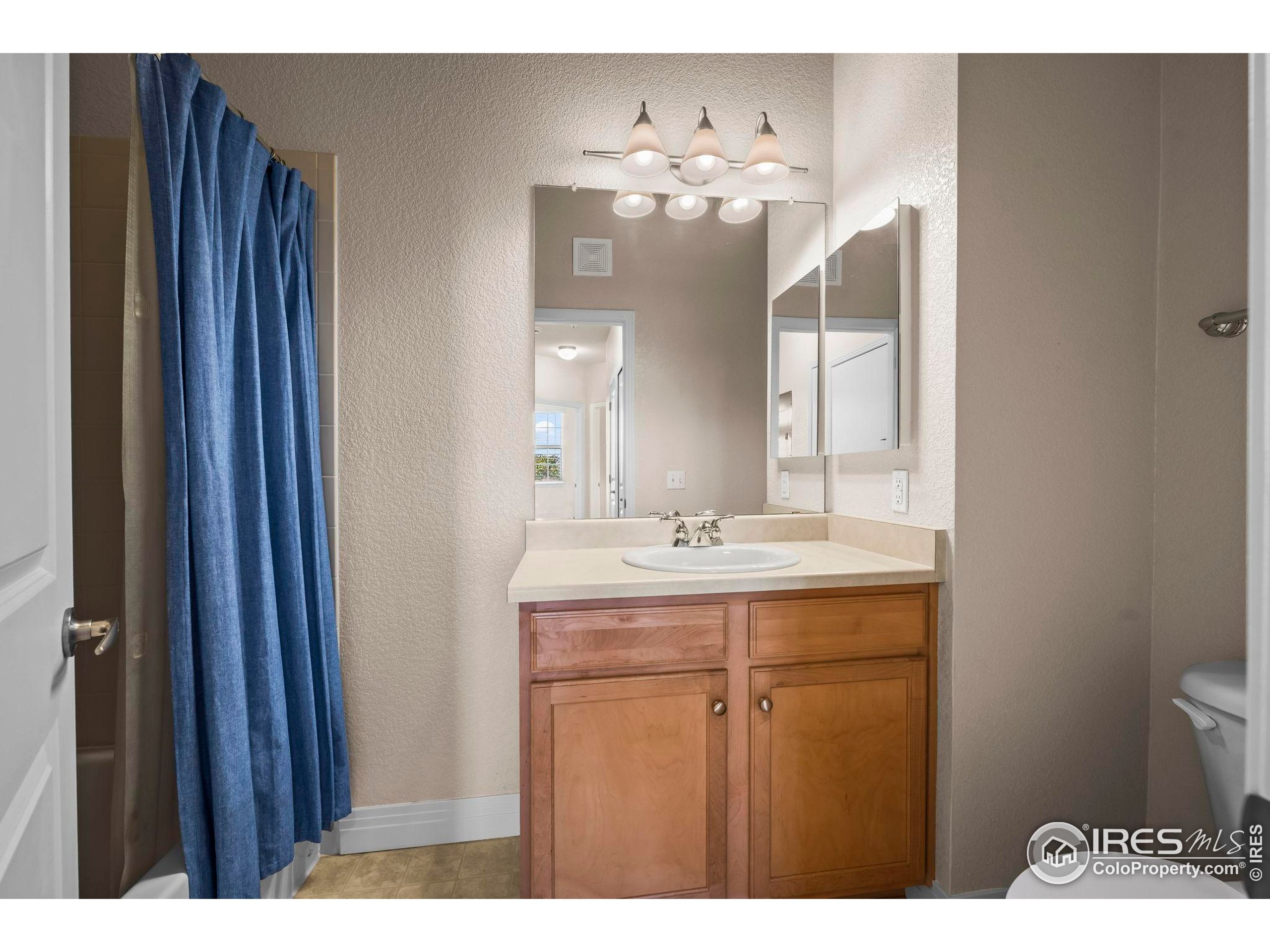 209 Quebec Street, Unit L Denver, CO 80220 - Photo 31 of 46 a bathroom with a sink and a mirror