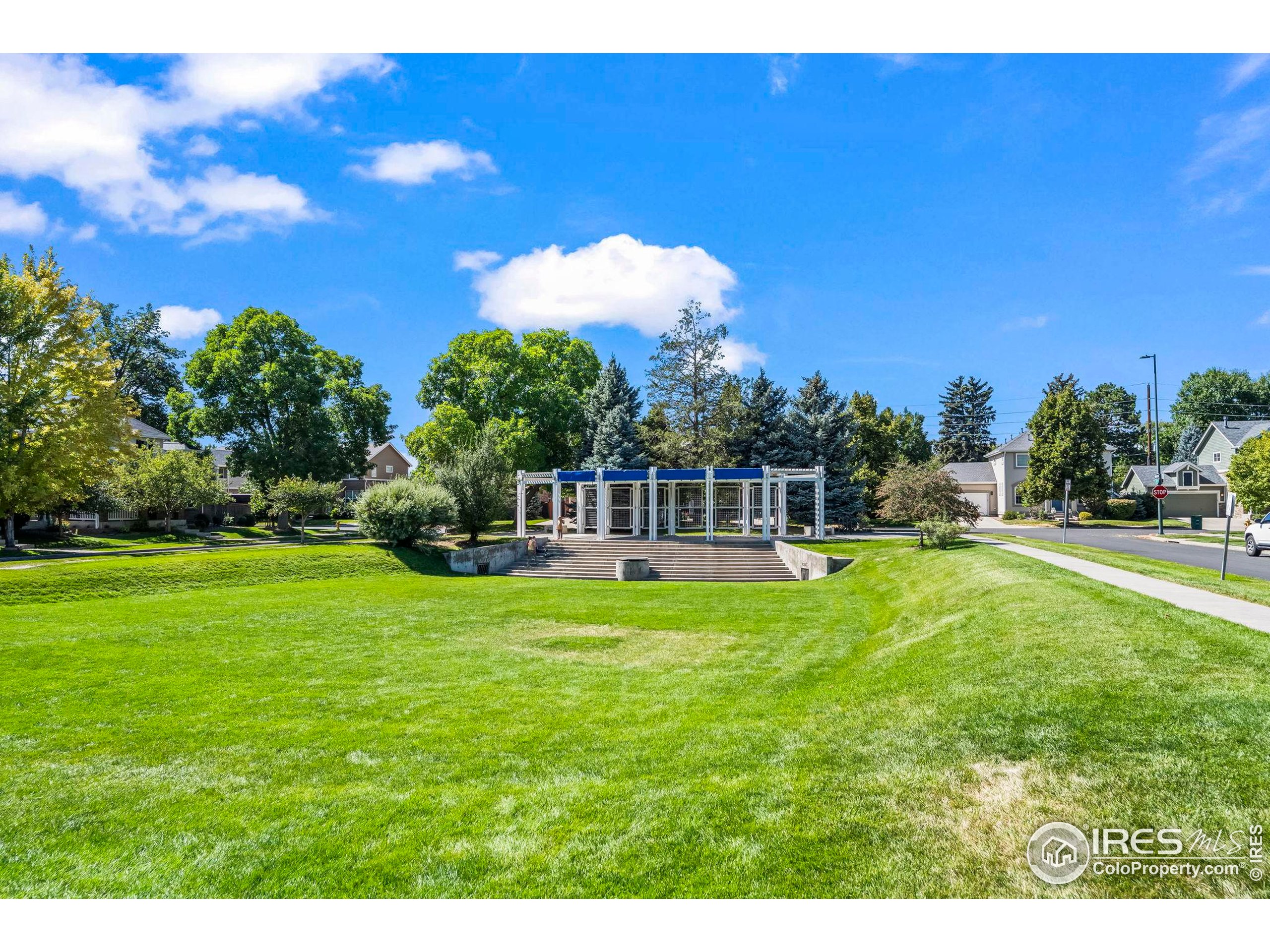 209 Quebec Street, Unit L Denver, CO 80220 - Photo 36 of 46 a view of a fountain in front of a house with a yard