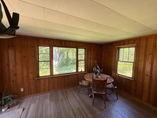 a dining room with furniture window wooden floor
