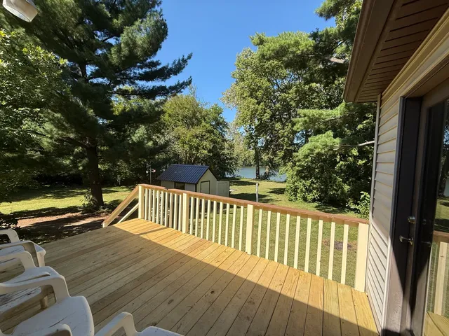 a view of balcony with wooden floor and fence