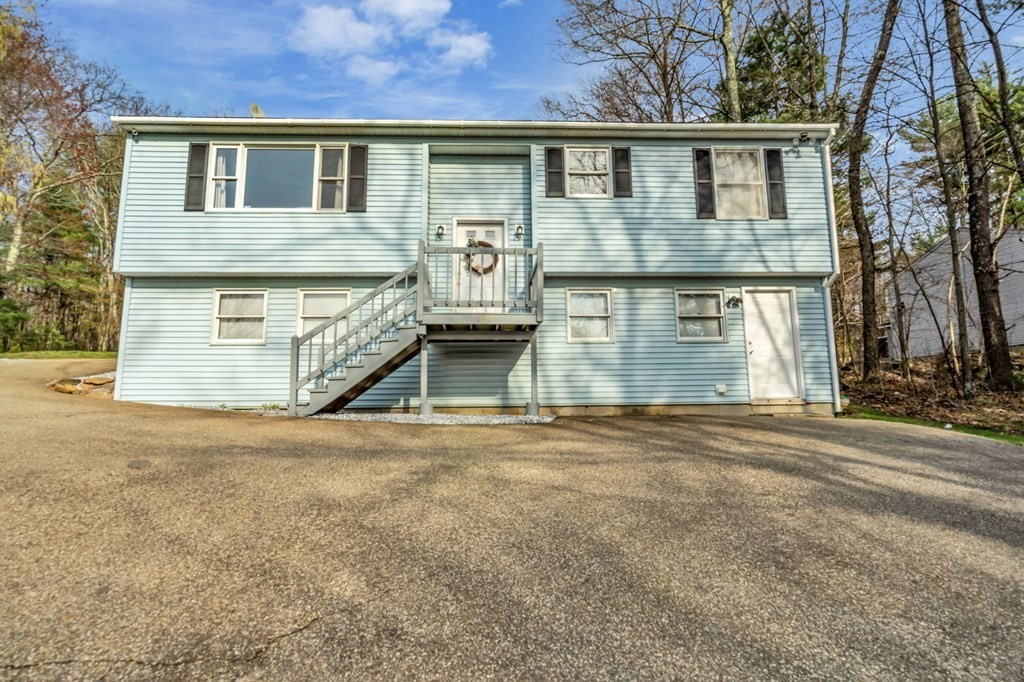 570 Cronin Road Warren, MA 01585 - Photo 1 of 25 a front view of a house with a yard and garage