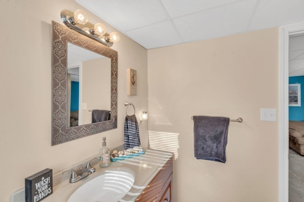 570 Cronin Road Warren, MA 01585 - Photo 20 of 25 a bathroom with a granite countertop sink and a mirror