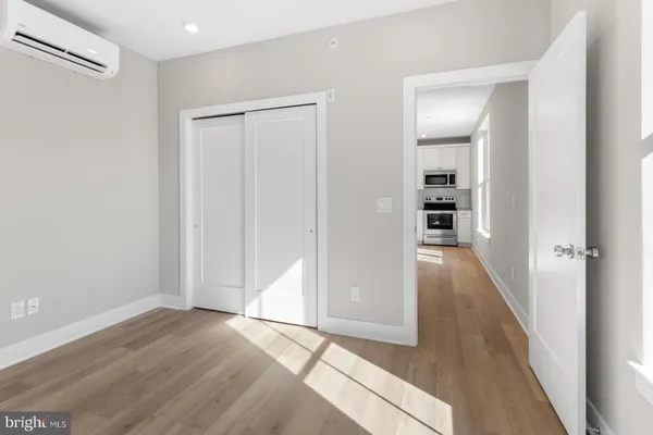 a view of hallway with wooden floor