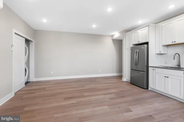 a view of a kitchen with a sink and refrigerator