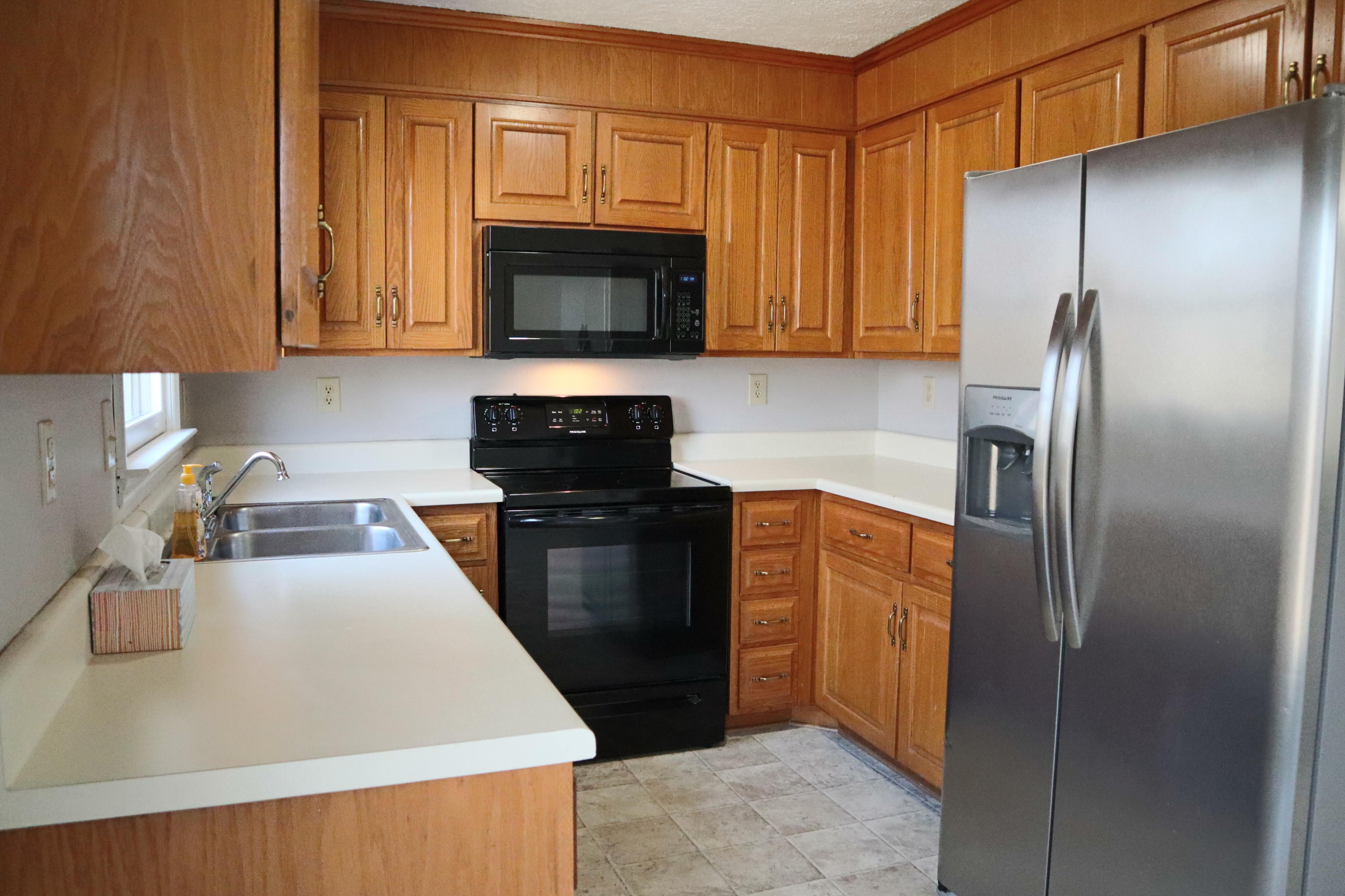 2664 Rutrough Road Southeast Roanoke, VA 24014 - Photo 2 of 19 a kitchen with a refrigerator sink and microwave