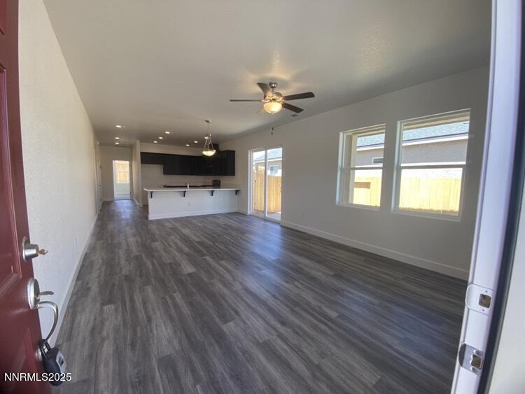 897 Agate Way Fernley, NV 89408 - Photo 2 of 8 wooden floor in an empty room with a window