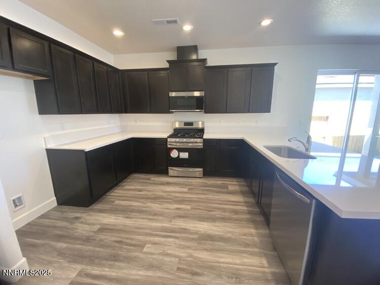 897 Agate Way Fernley, NV 89408 - Photo 3 of 8 a view of kitchen with stainless steel appliances kitchen island sink refrigerator and stove