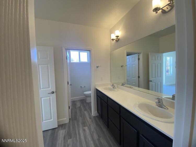 897 Agate Way Fernley, NV 89408 - Photo 5 of 8 a bathroom with a double vanity sink and mirror with shower
