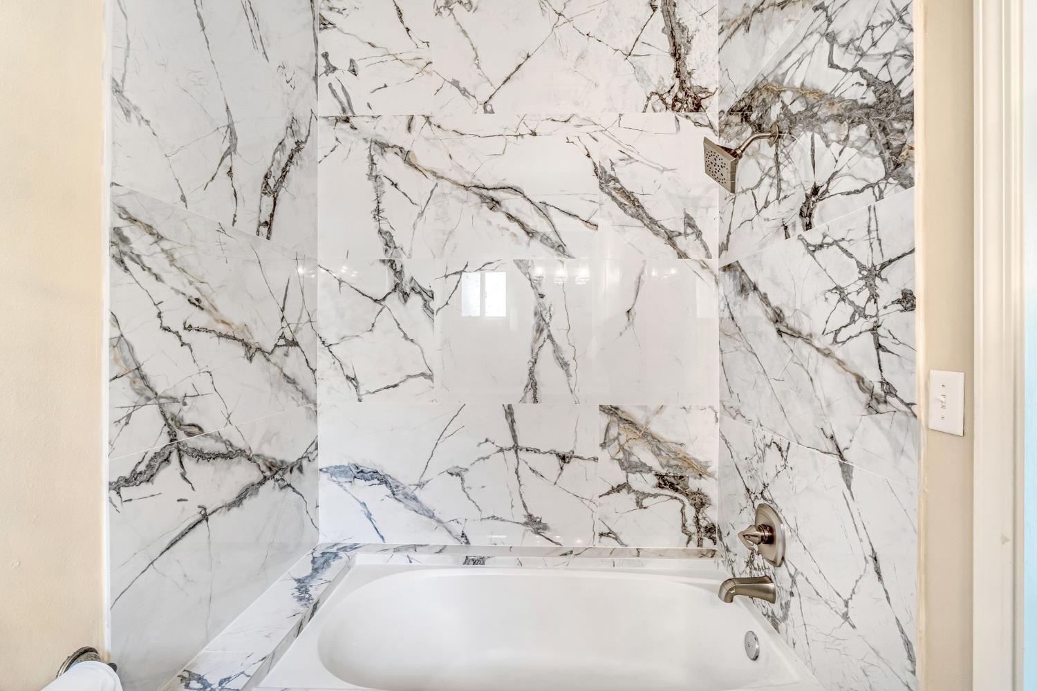 12 Breeze Way Madera, CA 93637 - Photo 25 of 56 a bathroom with a bathtub and sink