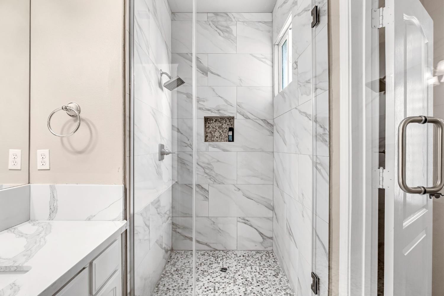 12 Breeze Way Madera, CA 93637 - Photo 30 of 56 a bathroom with a granite countertop shower a sink and a shower